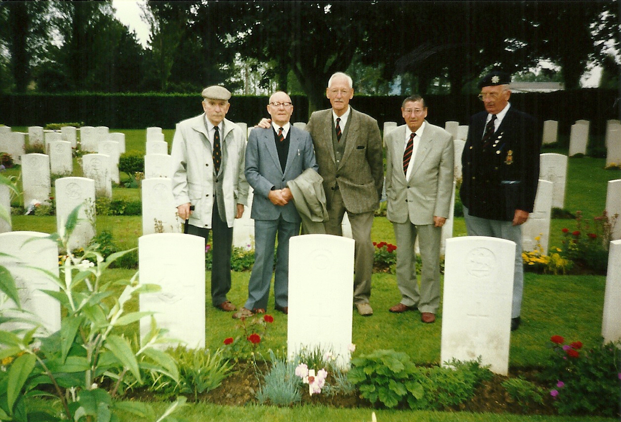 21 July 1994. Dennis Bell’s graveside, La Delivrande War Cemetery, Douvres, Normandy. LtoR: Messrs. Baker; Brooks; Johnson; Dabbs; Clark. Courtesy/© The Felix R. Johnson Collection.